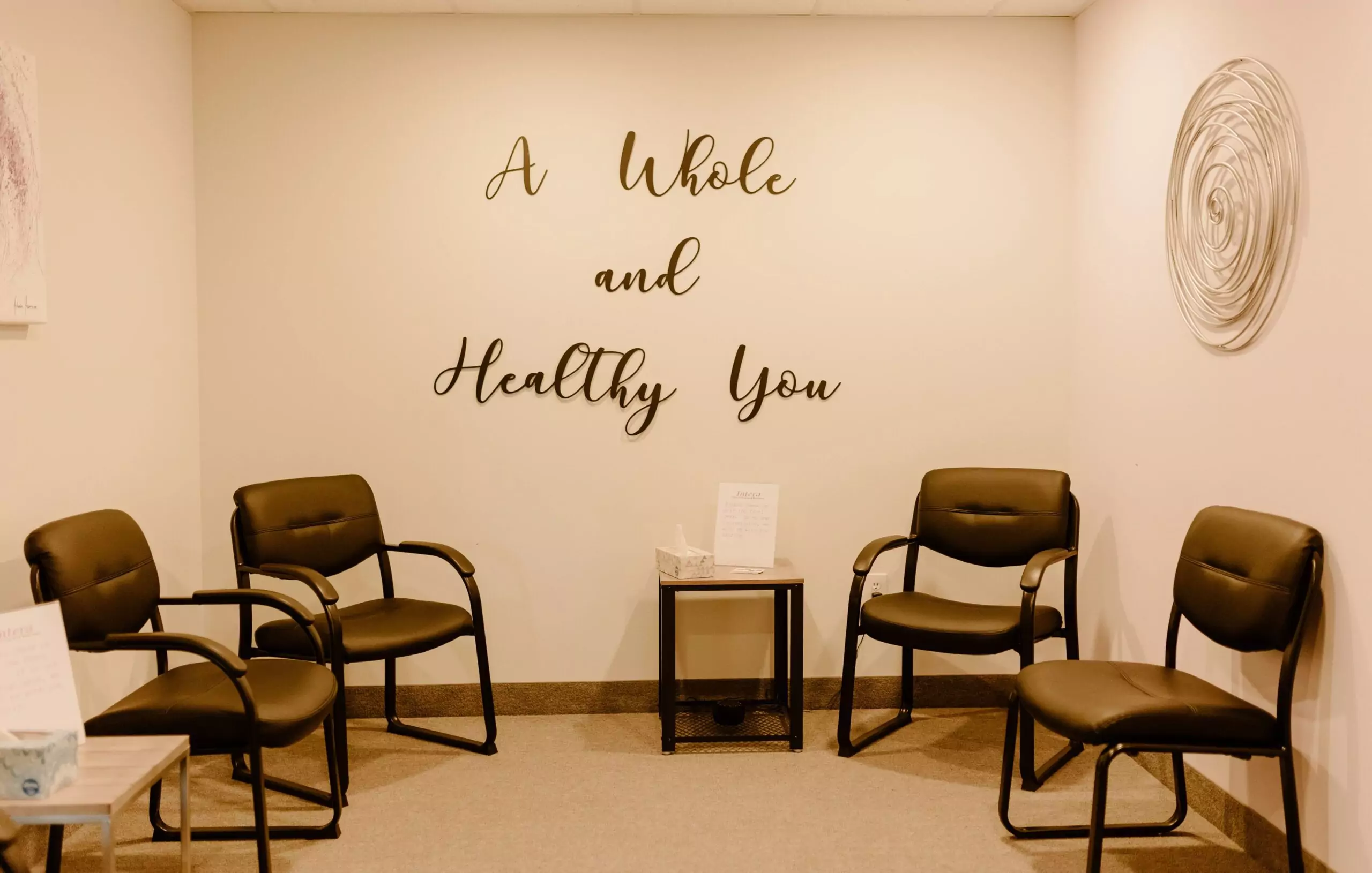 Whole-and-Healthy-You logo on the wall in the Intera office waiting room.